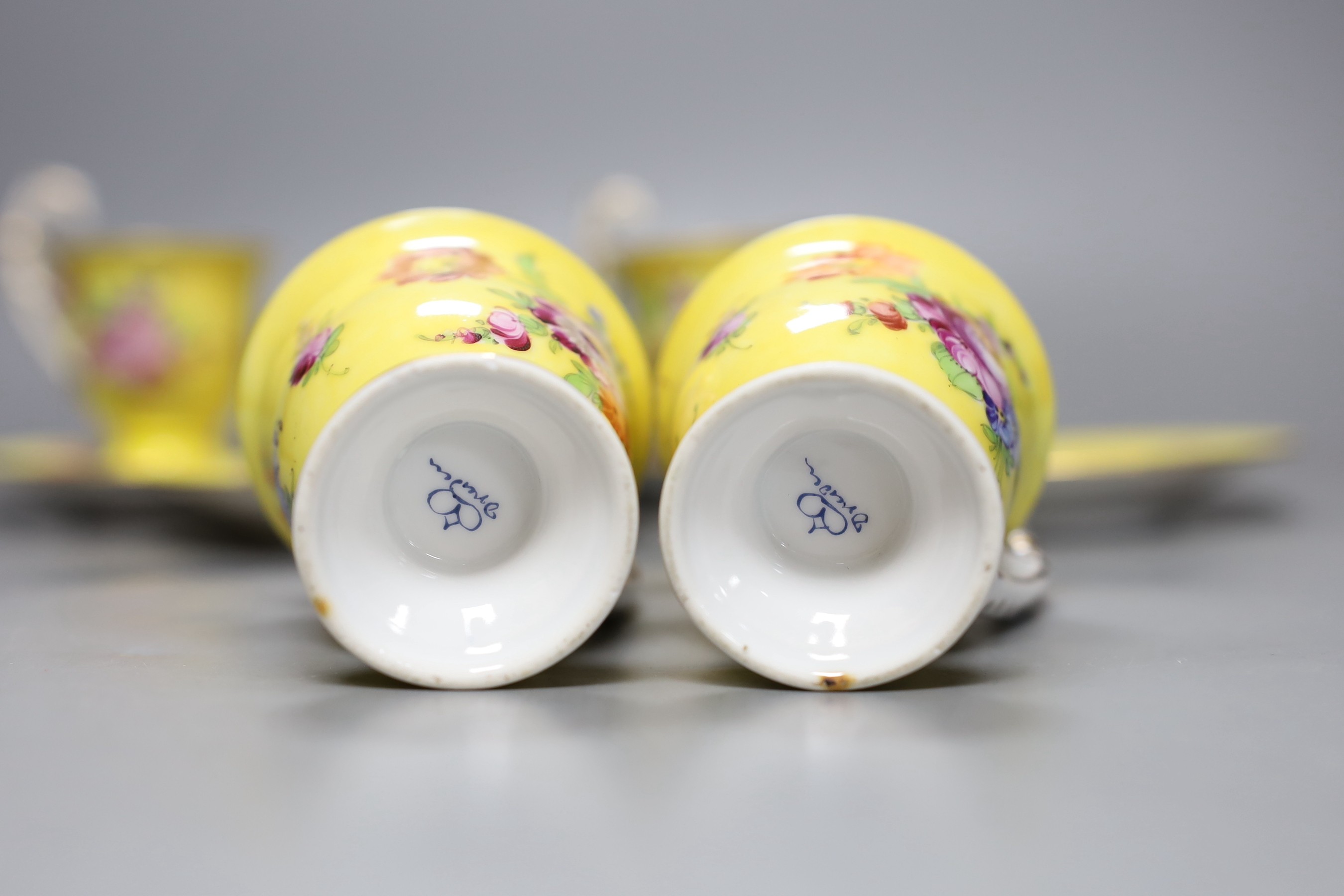 A set of four Dresden yellow ground cups and saucers